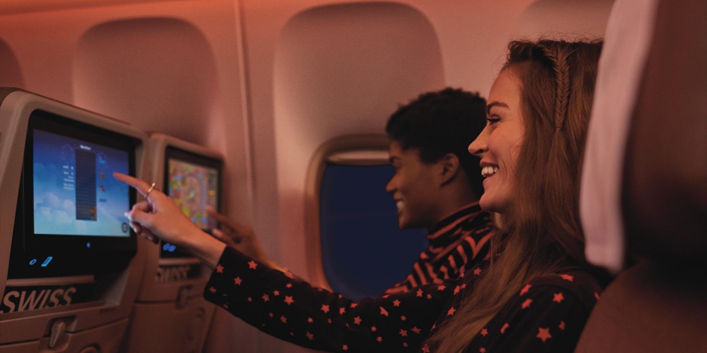 Entertainment screen showing on-board movies and digital features in SWISS Economy class.