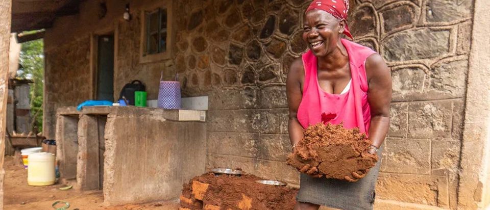 A woman is holding a handful of soil.