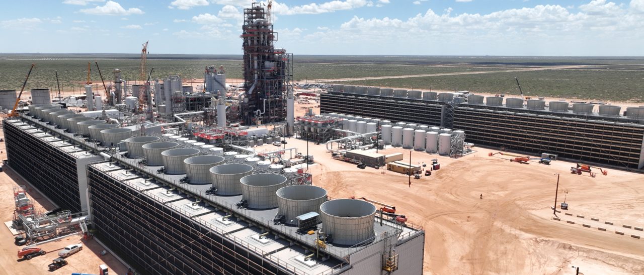 Oil refinery with a view of several large tanks.