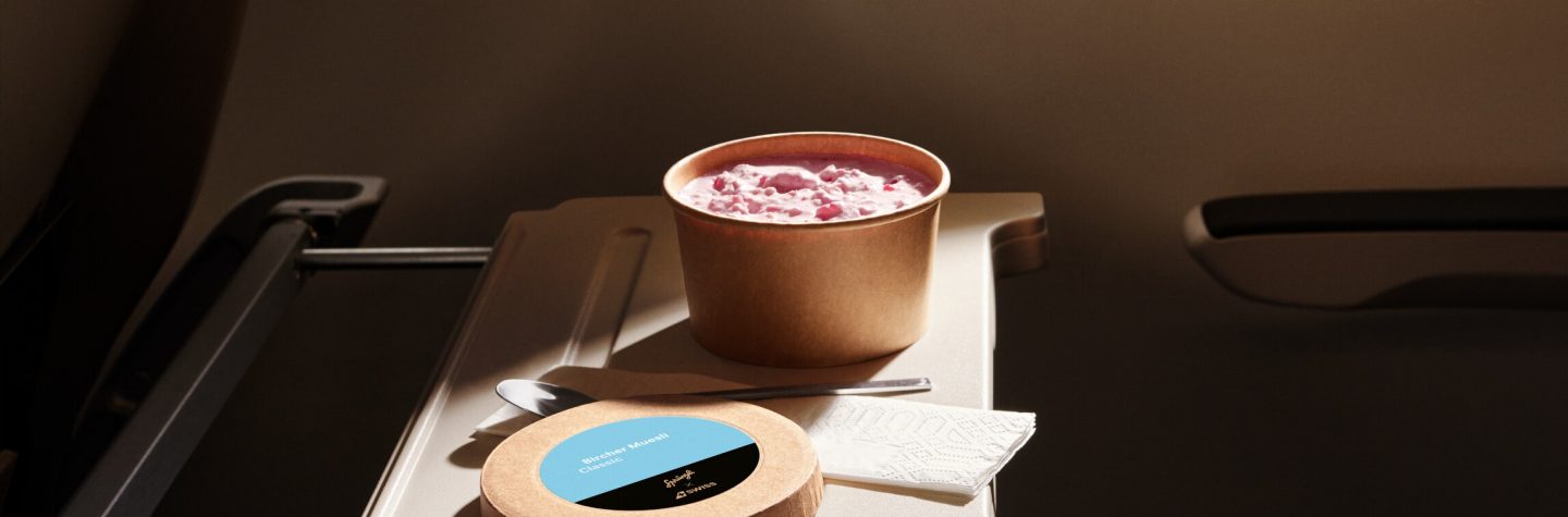 A bowl of food and a small round package on a tray.