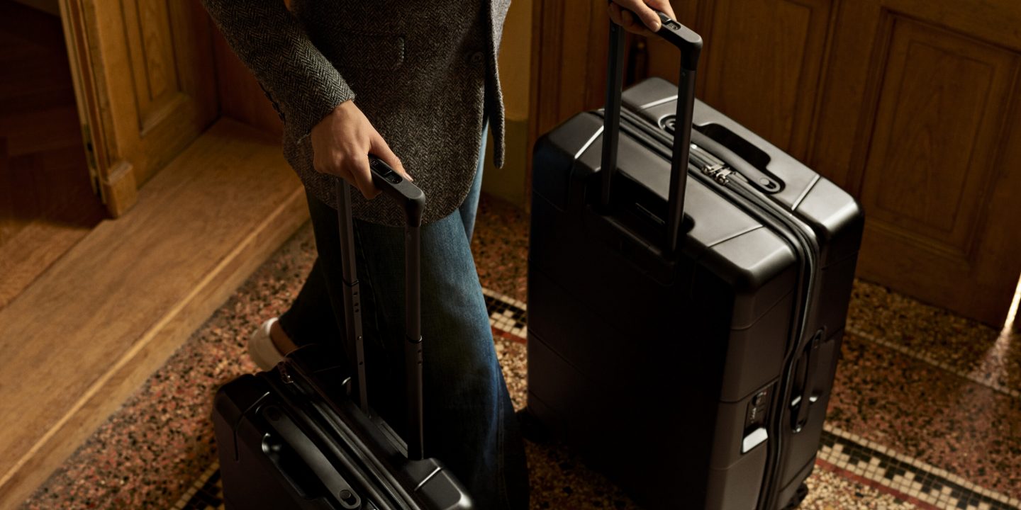 Individual holding a suitcase, symbolizing travel and the concept of excess baggage.
