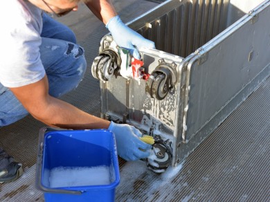 A trolley gets cleaned by hand as the first step in the refurbishment process.